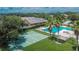Aerial view of a pool and basketball court with palm trees and lawn at 8620 Sandy Plains Dr, Riverview, FL 33578