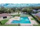 Aerial view of a pool, recreation building, and a basketball court in a community at 8620 Sandy Plains Dr, Riverview, FL 33578