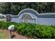 Oak Creek community sign with lush greenery and a gray stone entrance at 8620 Sandy Plains Dr, Riverview, FL 33578
