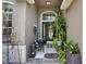 Cozy front porch featuring a seating area and vibrant plants provides a welcoming entrance at 8620 Sandy Plains Dr, Riverview, FL 33578