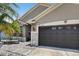 Attractive garage door enhances the home's exterior, blending seamlessly with its unique architectural style at 8620 Sandy Plains Dr, Riverview, FL 33578