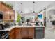 Features stainless appliances, cabinets, tile backsplash, dual sink, and an open layout into the living space at 8620 Sandy Plains Dr, Riverview, FL 33578