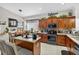 Well-equipped kitchen features stainless steel appliances, custom cabinets, center island with seating, and adjacent dining area at 8620 Sandy Plains Dr, Riverview, FL 33578