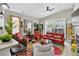 Open living room featuring ample seating, colorful rug, ceiling fan, large windows, and stylish decor at 8620 Sandy Plains Dr, Riverview, FL 33578