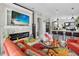 Modern living room featuring a fireplace, large screen TV, comfortable seating, and open to the kitchen at 8620 Sandy Plains Dr, Riverview, FL 33578