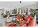 Open living room features ample seating, colorful rug, ceiling fan, and open to the kitchen and dining area at 8620 Sandy Plains Dr, Riverview, FL 33578