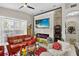 Bright living room featuring a modern fireplace, a red sofa, and unique decorations at 8620 Sandy Plains Dr, Riverview, FL 33578