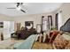 The main bedroom includes modern fixtures, ceiling fan, and a decorative rug at 8620 Sandy Plains Dr, Riverview, FL 33578