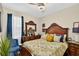 This bedroom features dark wood furniture, a ceiling fan, and a bed with decorative pillows at 8620 Sandy Plains Dr, Riverview, FL 33578