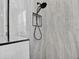Close up of shower head and tiled niche in modern marble shower at 8620 Sandy Plains Dr, Riverview, FL 33578