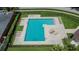 Aerial view of a community pool with lounge chairs and manicured landscaping at 8620 Sandy Plains Dr, Riverview, FL 33578