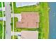 Aerial view of a home with a brick roof, paver driveway, and mature landscaping at 8717 Sanders Tree Loop, Wesley Chapel, FL 33545