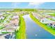 An aerial view of a residential neighborhood with houses alongside a large lake at 8717 Sanders Tree Loop, Wesley Chapel, FL 33545