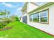 Well-maintained backyard featuring lush green grass, modern design, and partial fence views at 8717 Sanders Tree Loop, Wesley Chapel, FL 33545