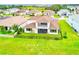 Beautiful backyard featuring a well-maintained lawn, partial fence, and a screened-in patio with balcony at 8717 Sanders Tree Loop, Wesley Chapel, FL 33545