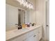 Bathroom with dual sinks and a large mirror with lots of lighting at 8717 Sanders Tree Loop, Wesley Chapel, FL 33545