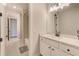 Bathroom featuring a sink with white cabinets and an open doorway to the bathtub and shower at 8717 Sanders Tree Loop, Wesley Chapel, FL 33545