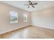 Bright bedroom features luxury vinyl plank floors, ceiling fan, and double-paned windows at 8717 Sanders Tree Loop, Wesley Chapel, FL 33545