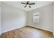 Bright bedroom features hardwood floors, ceiling fan, and natural light at 8717 Sanders Tree Loop, Wesley Chapel, FL 33545