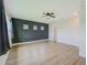Bedroom with three windows and dark accent wall at 8717 Sanders Tree Loop, Wesley Chapel, FL 33545