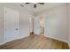 Bedroom with hardwood floors and access to a private bathroom at 8717 Sanders Tree Loop, Wesley Chapel, FL 33545