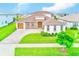 An attractive single-Gathering home with three-car garage, beautiful stone accents, and well-manicured landscaping at 8717 Sanders Tree Loop, Wesley Chapel, FL 33545