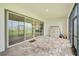 Enclosed screened in lanai with tile and exterior views at 8717 Sanders Tree Loop, Wesley Chapel, FL 33545