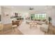 Bright living space with an open floor plan, light wood floors, neutral furniture and contemporary finishes at 8717 Sanders Tree Loop, Wesley Chapel, FL 33545