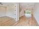 Spacious living area showcasing an open floor plan, hardwood floors, and staircase access to the upper level at 8717 Sanders Tree Loop, Wesley Chapel, FL 33545