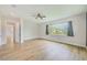 Bright bedroom with wood-look floors, ceiling fan, and ensuite access at 8717 Sanders Tree Loop, Wesley Chapel, FL 33545
