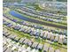 Aerial view of a residential neighborhood featuring multiple houses surrounding a long lake at 9650 Sage Creek Dr, Ruskin, FL 33573
