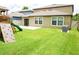 Spacious backyard with a green lawn, a patio, and a wooden climbing structure at 9650 Sage Creek Dr, Ruskin, FL 33573