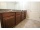 Bathroom vanity with granite countertops and tiled floors near the closed door at 9650 Sage Creek Dr, Ruskin, FL 33573