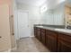 Bathroom with a double vanity with granite countertops, tiled floors and shower at 9650 Sage Creek Dr, Ruskin, FL 33573