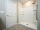 Bathroom with a bright white tiled shower and a door at 9650 Sage Creek Dr, Ruskin, FL 33573