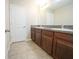 Bathroom with double vanity, granite countertop, tile floor, and large mirror at 9650 Sage Creek Dr, Ruskin, FL 33573