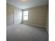 Comfortable bedroom with carpeted floors, closet, and a bright window at 9650 Sage Creek Dr, Ruskin, FL 33573