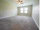 Carpeted bedroom featuring a ceiling fan and windows providing natural light at 9650 Sage Creek Dr, Ruskin, FL 33573