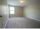 Bedroom with carpeted floors and a window offering natural light at 9650 Sage Creek Dr, Ruskin, FL 33573