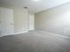 Spacious carpeted bedroom with two doors and neutral paint at 9650 Sage Creek Dr, Ruskin, FL 33573