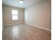 Well-lit bedroom showcasing a neutral color palette and a window for natural light at 9650 Sage Creek Dr, Ruskin, FL 33573
