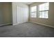 Bedroom featuring neutral paint, a closet, two windows and neutral carpeting at 9650 Sage Creek Dr, Ruskin, FL 33573