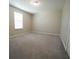Bright bedroom featuring neutral walls, carpeted floors, and a window for natural light at 9650 Sage Creek Dr, Ruskin, FL 33573
