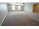 Large bonus room with a ceiling fan and natural light from two windows, perfect for relaxing or entertaining at 9650 Sage Creek Dr, Ruskin, FL 33573