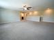 Spacious bonus room featuring neutral walls, carpeted floors, and a ceiling fan for comfortable living at 9650 Sage Creek Dr, Ruskin, FL 33573