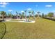 Well-maintained dog park featuring green grass, palm trees, picnic tables and walking paths at 9650 Sage Creek Dr, Ruskin, FL 33573
