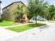 Residential home boasts an attached garage and a manicured front yard at 9650 Sage Creek Dr, Ruskin, FL 33573