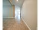 Bright hallway featuring ceramic tile flooring and neutral wall colors at 9650 Sage Creek Dr, Ruskin, FL 33573