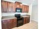 Well-equipped kitchen featuring dark wood cabinets and modern black appliances at 9650 Sage Creek Dr, Ruskin, FL 33573