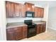 Kitchen featuring dark wood cabinets and modern black appliances at 9650 Sage Creek Dr, Ruskin, FL 33573